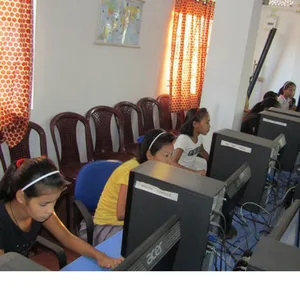 A girl learning on a computer in a skills class