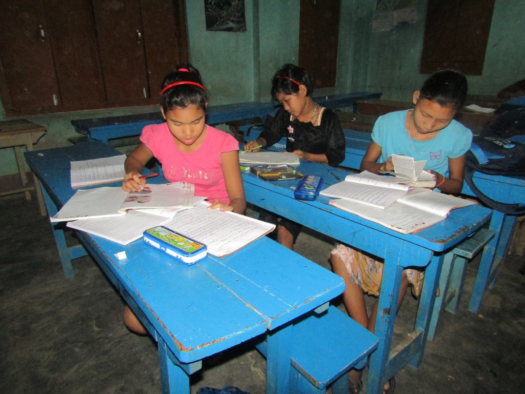 A girl supported by Support-A-Girl learning at school