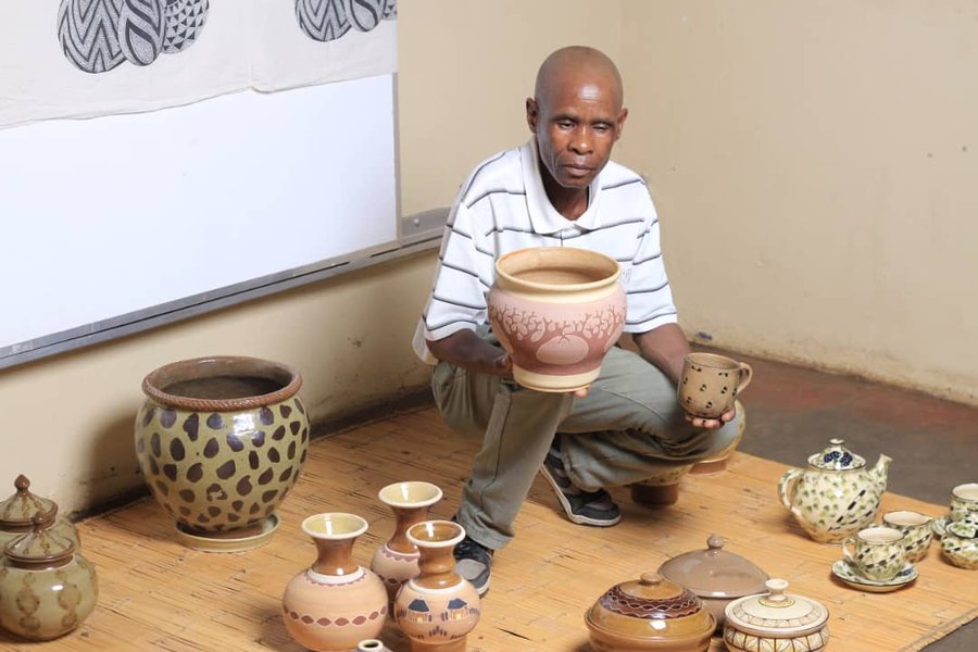 An artisan shaping clay at the pottery wheel